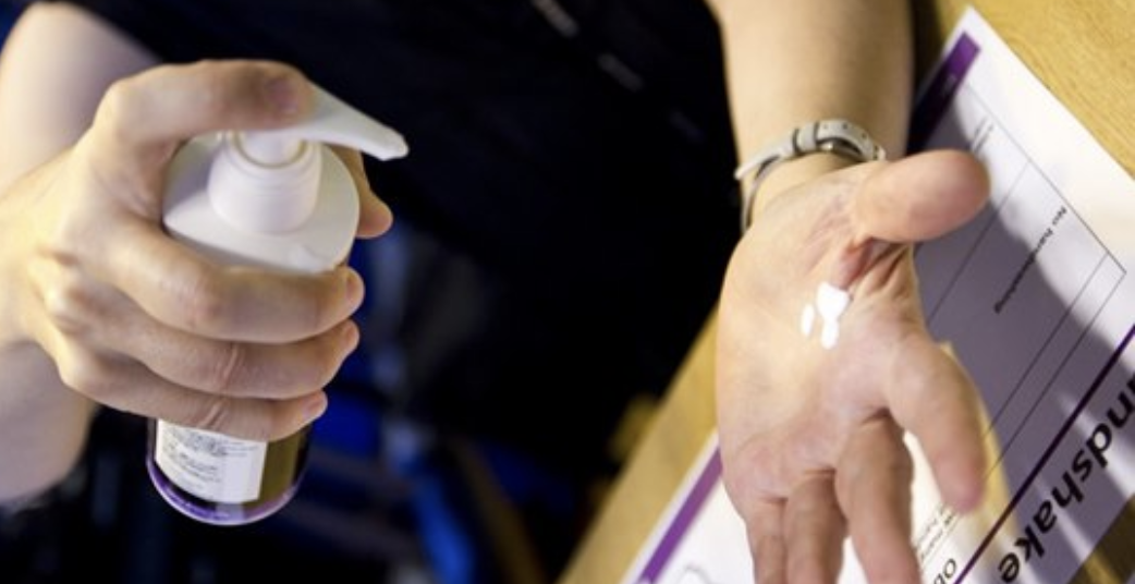 Image to of spray bottle and hand